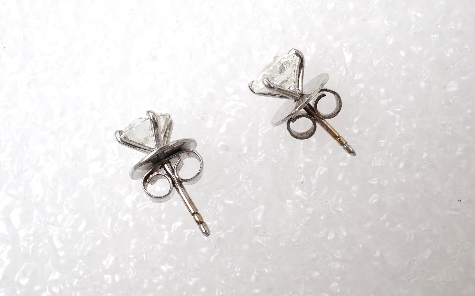 A pair of diamond stud earrings